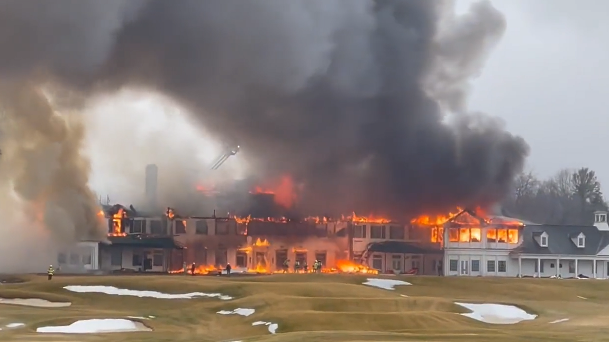 Flames swallowed historic Oakland Hills Country Club as a fire raged through the building, photos and video show. 