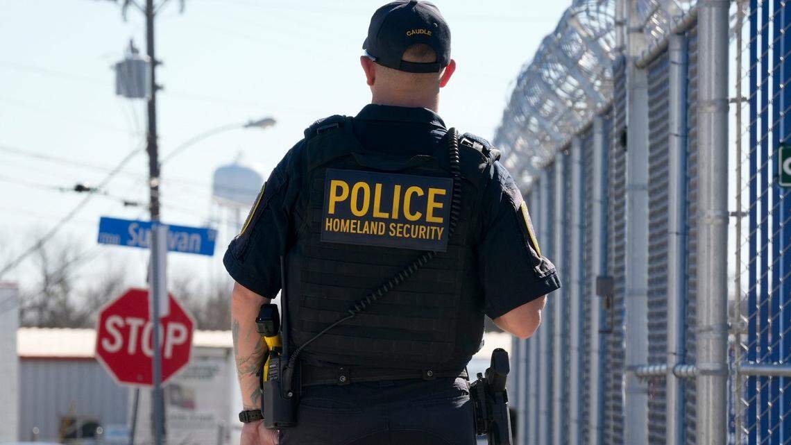 Department of Homeland Security Inspector Marshall Caudle, watches a protest at a new Immigration and Customs Enforcement facility in Pflugerville on Feb. 1, 2025. The ICE facility is expected to open in April.