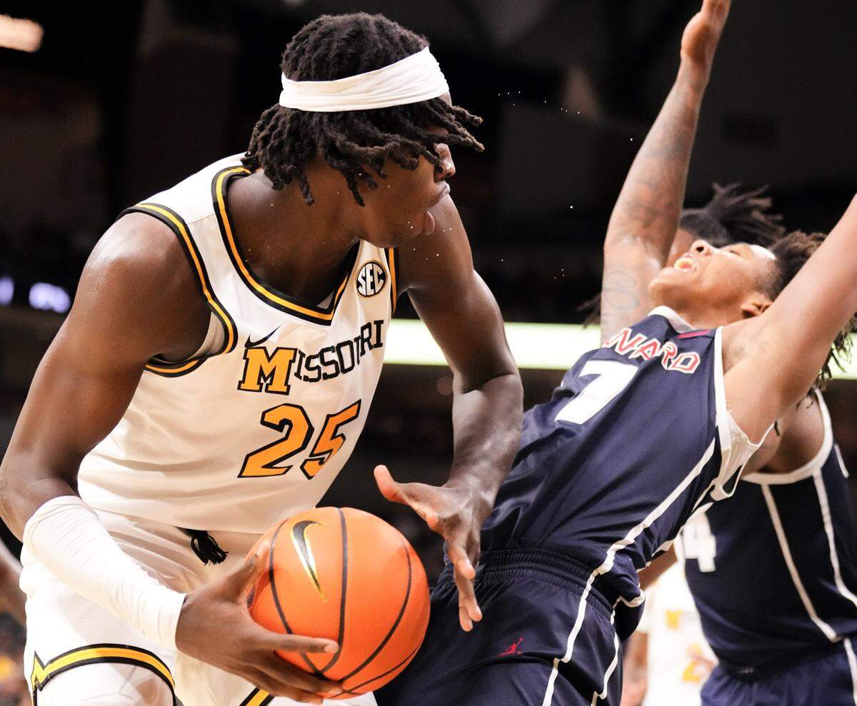 Missouri Tigers guard Mark Mitchell, left, goes up for a shot and is fouled by Howard Bison guard Blake Harper during MU’s home basketball opener at Mizzou Arena in Columbia, Mo., on Friday, Nov. 8, 2024.