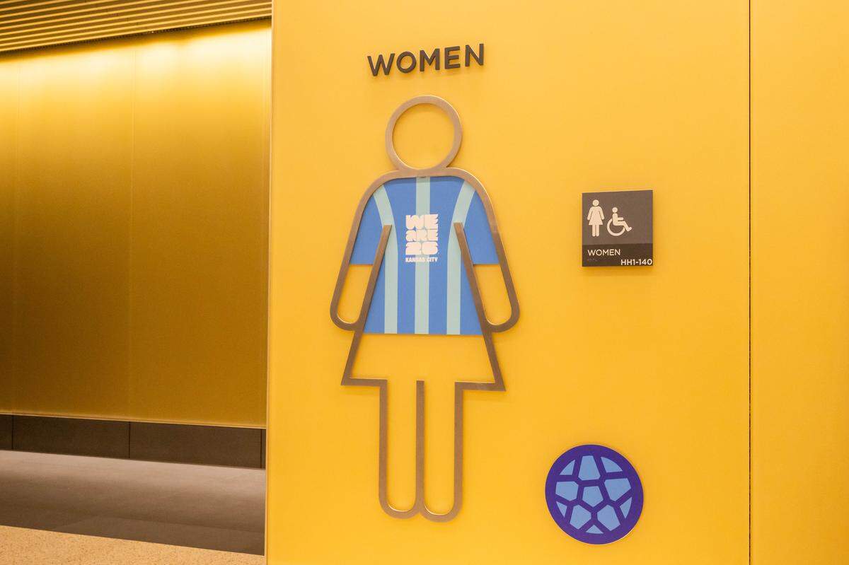 A women’s restroom sign wears a soccer jersey at Kansas City International Airport, on Wednesday, April 29, 2026. 