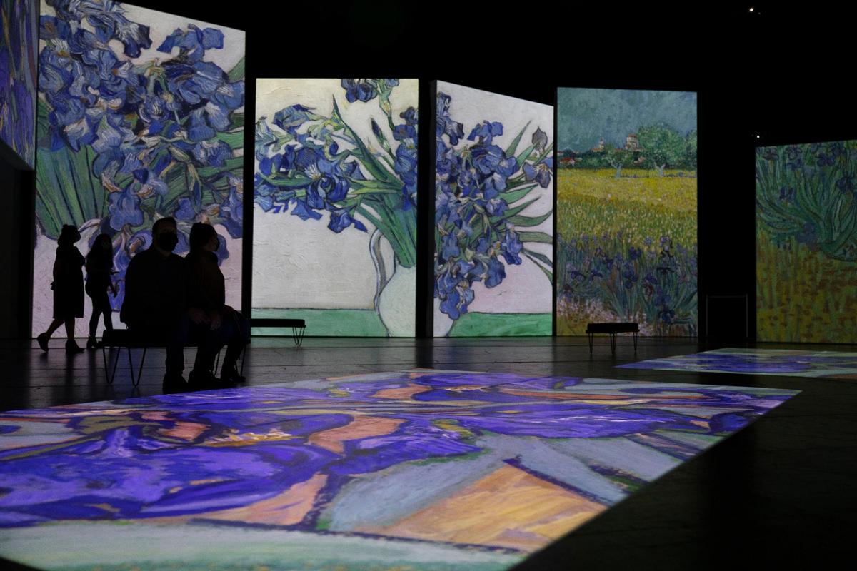 Austin Williams and Taylor Williams watch a series of moving paintings projected on screens and the floor at the Van Gogh Alive preview event Friday, October 22, 2021, at Starlight Theatre. It was a special viewing of the supersized artwork of 19th century painter Vincent Van Gogh. The interactive exhibit displays the artist’s work in giant projections along with a musical soundtrack. Starlight and the Nelson-Atkins Museum of Art are sponsors of the exhibit.