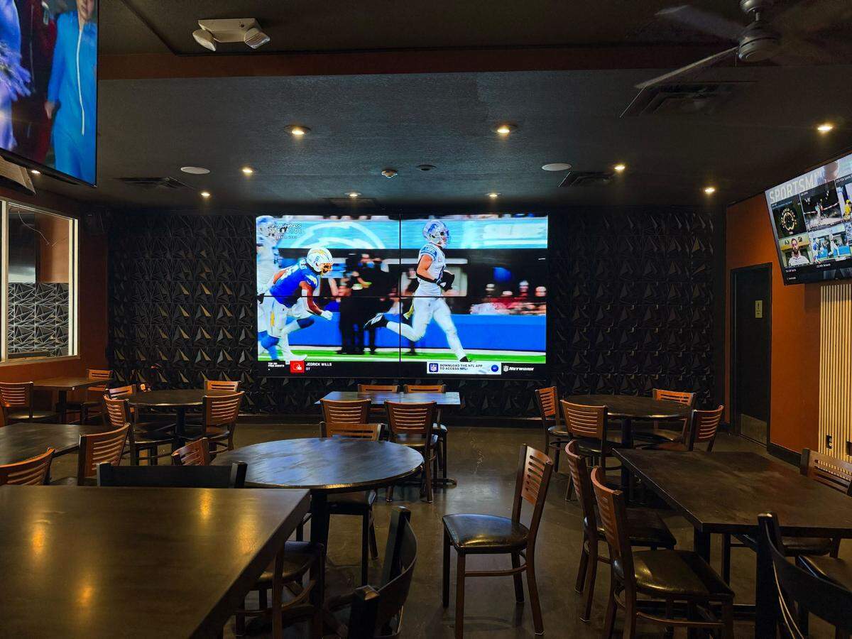 The large television inside AJ’s Bar & Grill plays a football replay on a Tuesday afternoon.