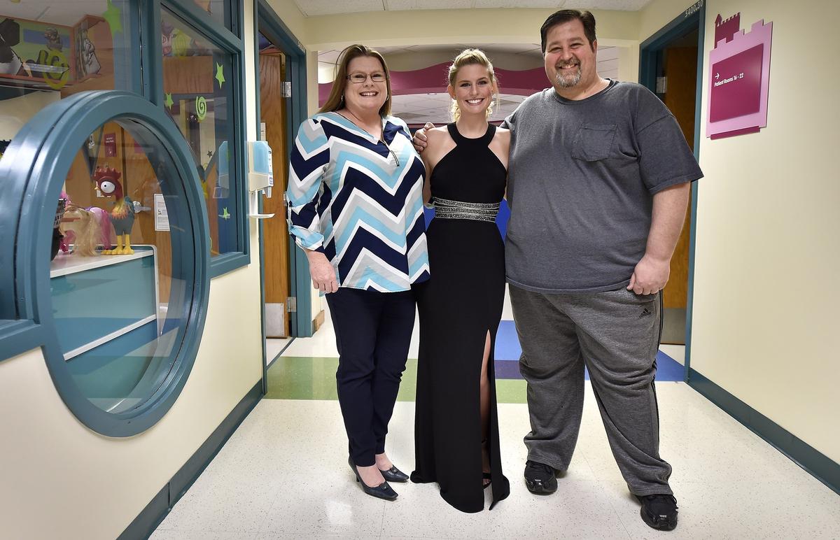 Children's Mercy Hospital held its first prom - red carpet and all - Friday, April 13, 2018. Seventeen-year-old Alyssa Williamson of Liberty (center), said she fell in love with the black dress when she tried it on. Her parents, Kathy and Dave Williamson, were with Alyssa at the hospital.