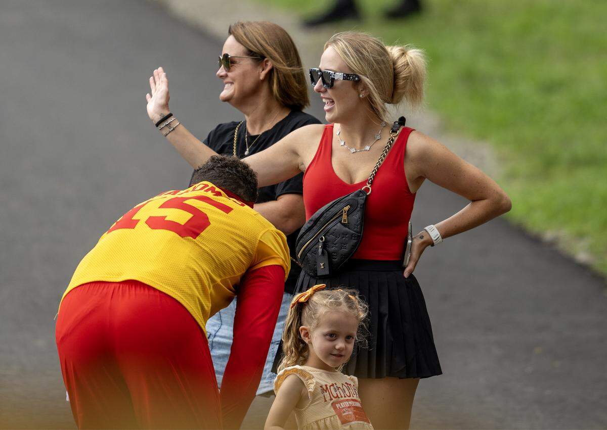 Kansas City Chiefs quarterback Patrick Mahomes leans down to talk to his daughter, Sterling Mahomes, 4, as his wife Brittany Mahomes waves during a visit to training camp at Missouri Western State University on Wednesday, July 30, 2025, in St. Joseph, Missouri. 