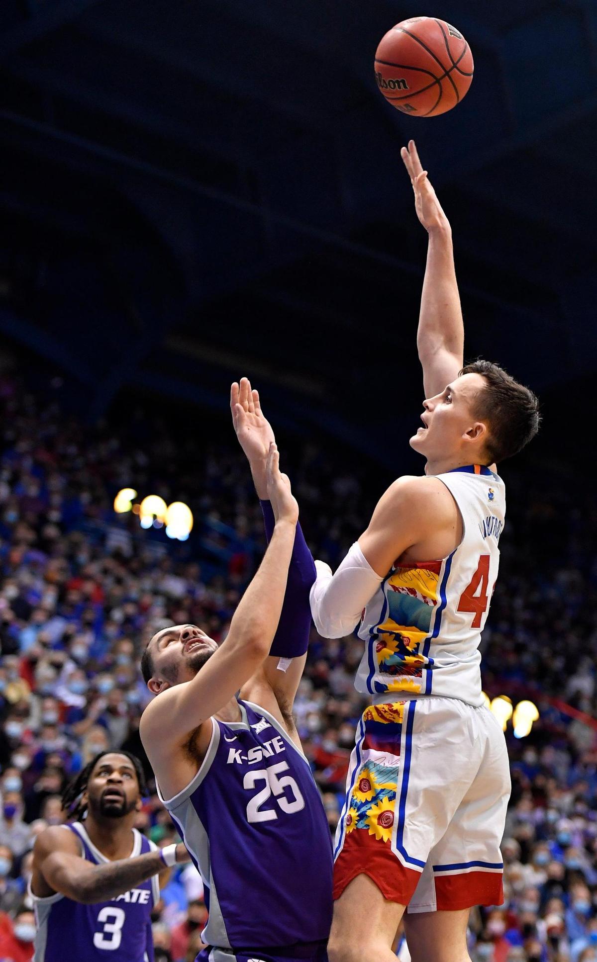 KU’s Mitch Lightfoot hits a hook over KSU’s Ismael Massoud on Tuesday at Allen Fieldhouse. KU beat KSU 102-83.