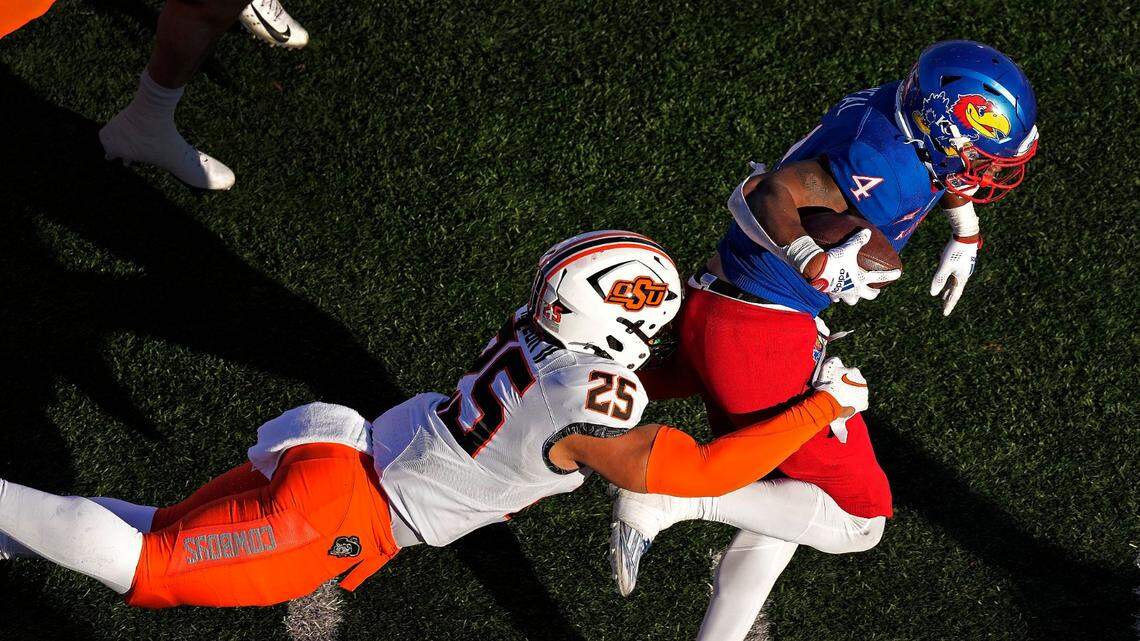 Kansas running back Devin Neal, right, was a game-wrecker against Oklahoma State on Saturday in Lawrence, Kan., running for 224 yards on 32 carries and catching six passes for another 110 yards as the Jayhawks beat up on the Cowboys, 37-16