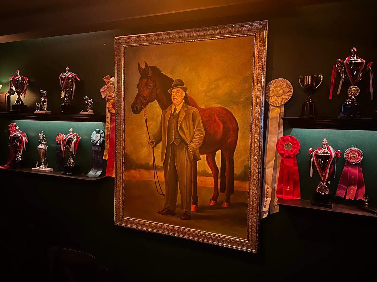 A painting of Tom Pendergast with his racehorse, Climax, on the walls of Tom’s Town’s basement bar The Vault.