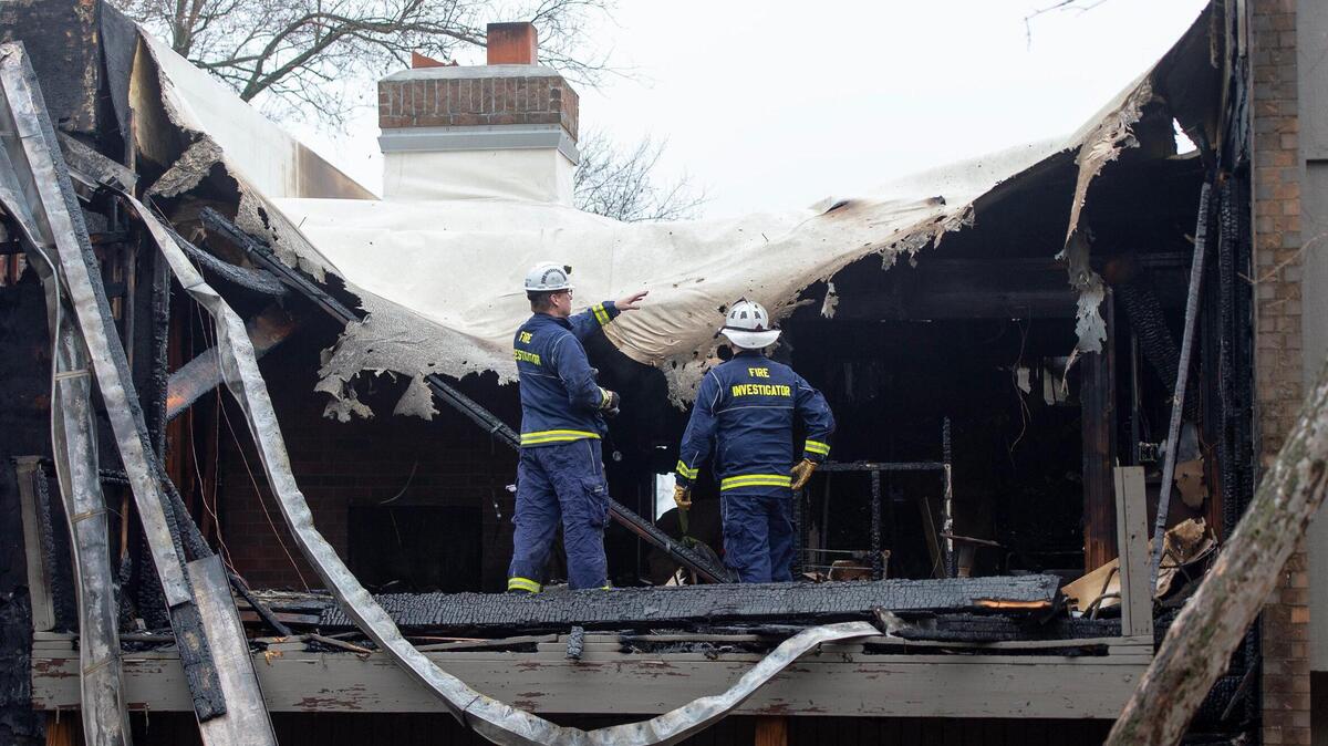 Overland Park fire investigators inspect damage to an apartment that was destroyed in a fire at the Meadowlark Hill Apartments on Thursday, Dec. 8, 2022, in Overland Park, Kan.