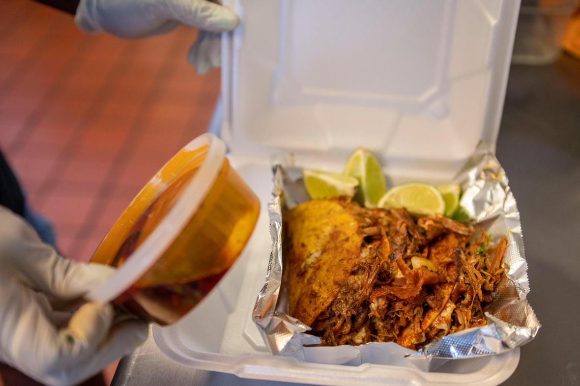 Ashley Frazier packs an order of house-made birria tacos during lunch hours at the new This & That Eatery on Troost.