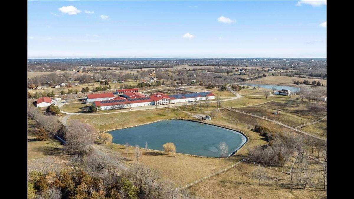 The property at 9100 Cedar Niles Road in Lenexa features a four-bedroom house and the largest equestrian facility in the area, with 84 stable.