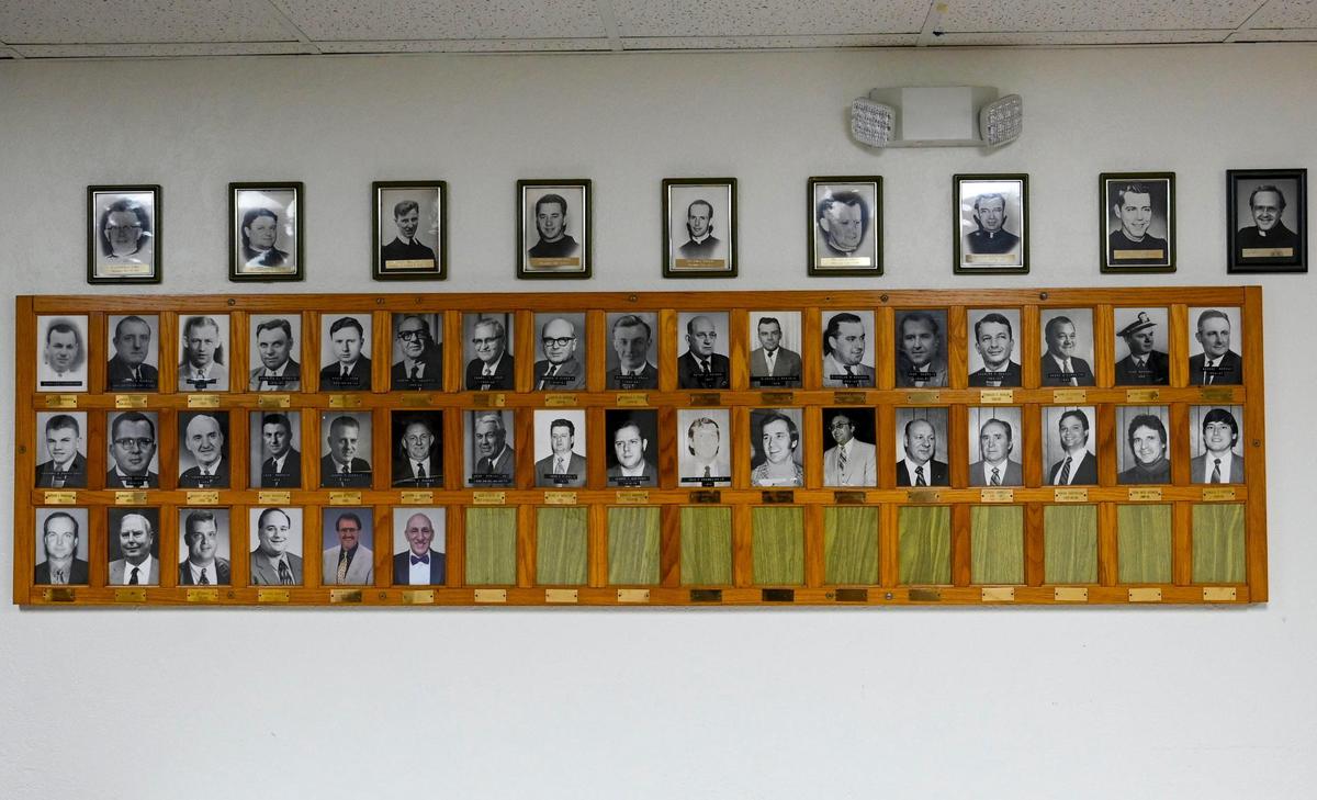 Portraits of past presidents and priests line the entryway of St. John Catholic Club.