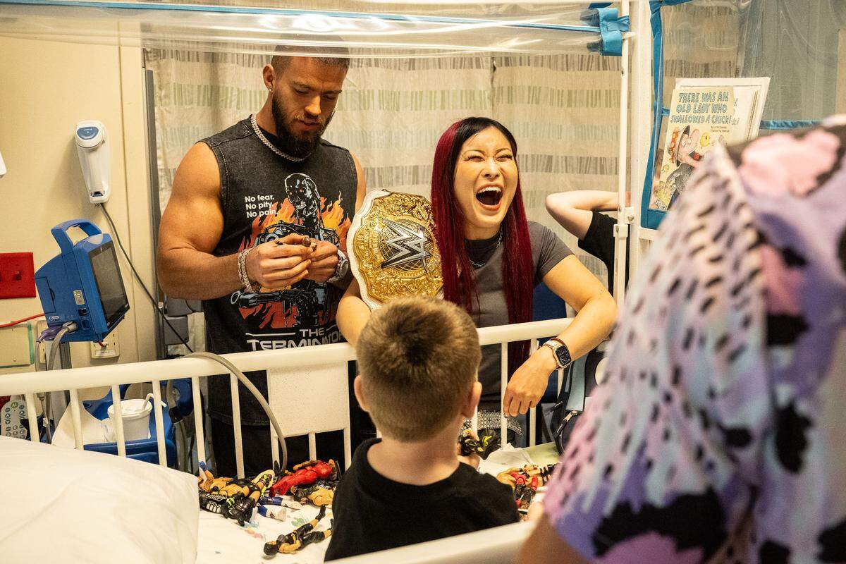 WWE superstars Austin Theory (left) and Iyo Sky visit kids at Children’s Mercy in Kansas City Monday, April 28.