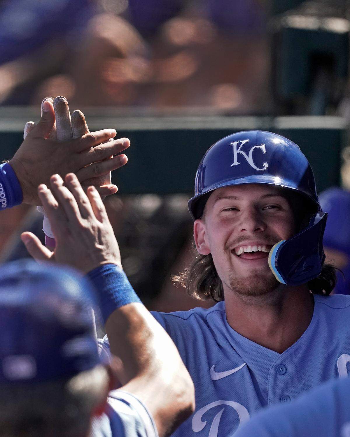 Kansas City Royals infielder Bobby Witt Jr. celebrates in the dugout after scoring on a sacrifice fly during a recent spring training game against the Cincinnati Reds in Surprise, Ariz.