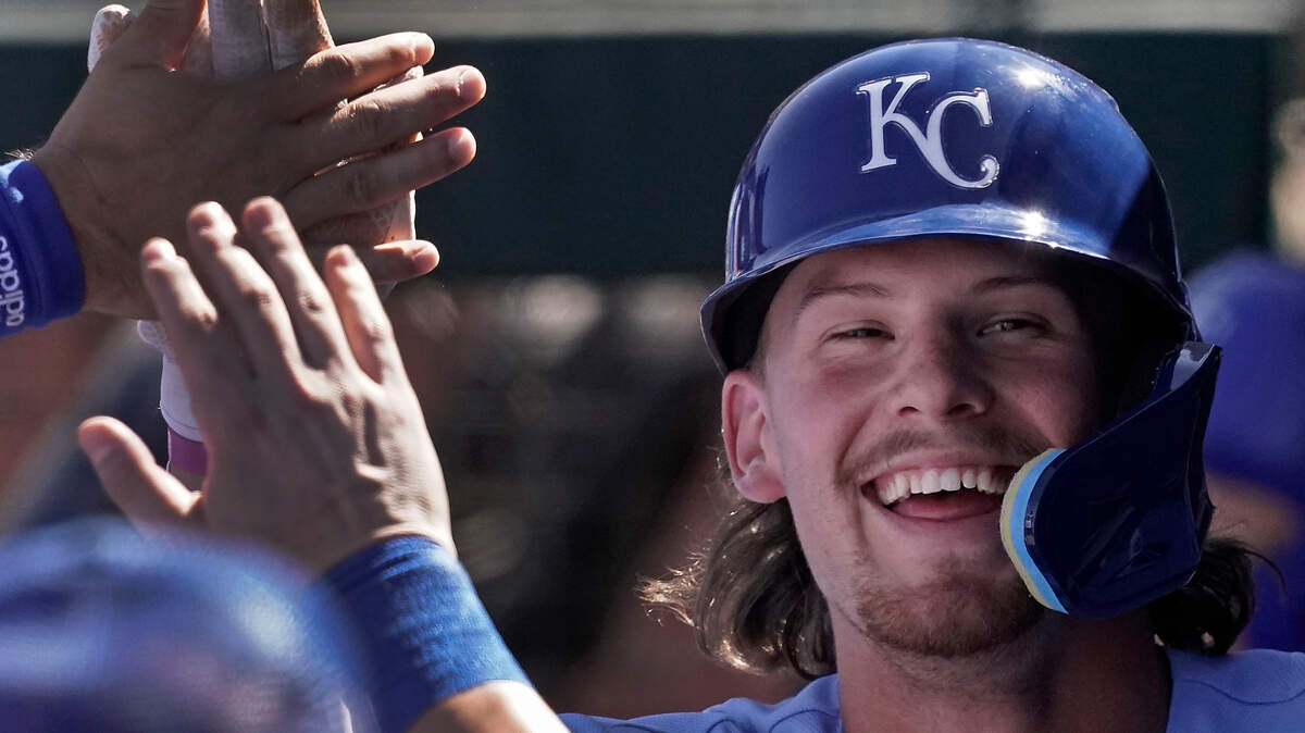Kansas City Royals infielder Bobby Witt Jr. celebrates in the dugout after scoring on a sacrifice fly during a recent spring training game against the Cincinnati Reds in Surprise, Ariz.