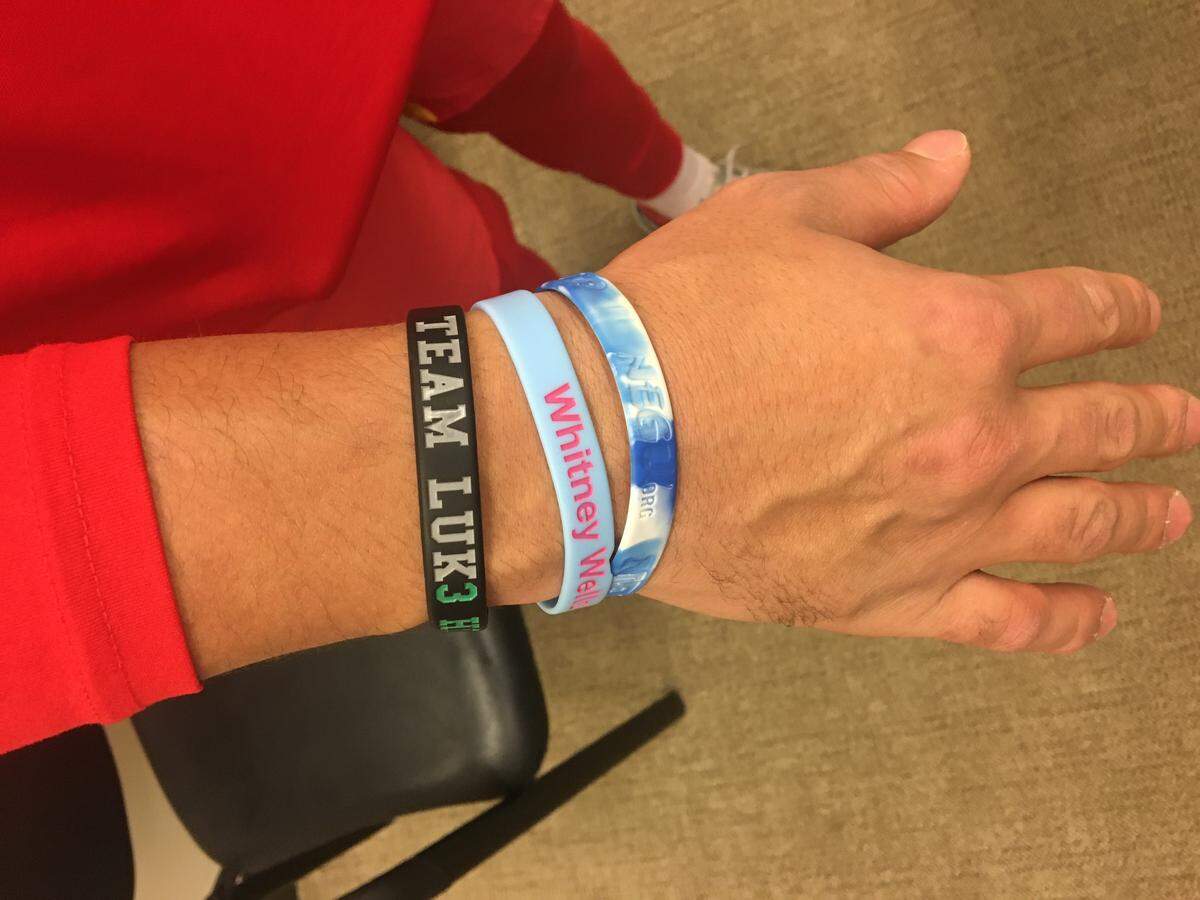 On his right wrist, Chiefs quarterback Patrick Mahomes wears wristbands honoring Luke Siegel, Whitney Wells and Cade Spinello.