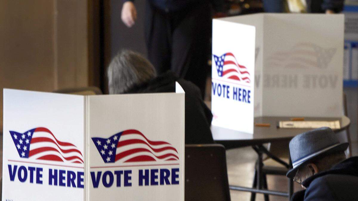 Voters fill out their ballots Tuesday at St. Paul's Episcopal Church, 11 East 40th St. A steady stream of people filed into the church to cast their votes.