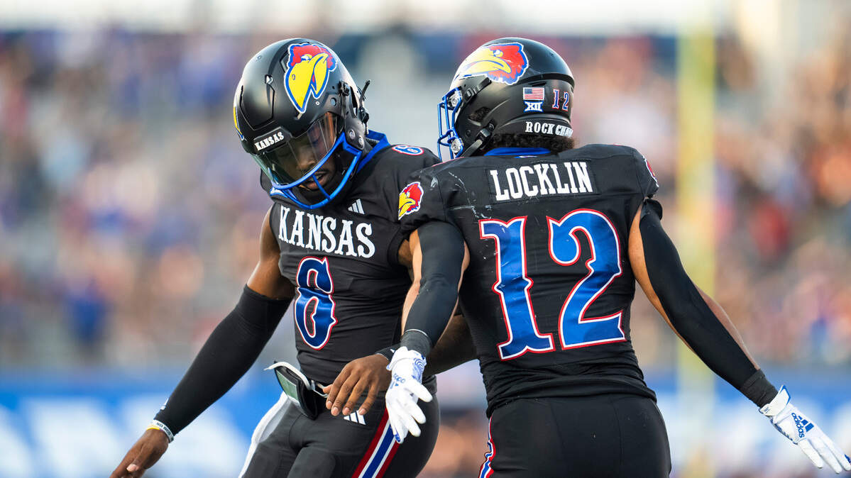 Kansas Jayhawks quarterback Jalon Daniels (6) celebrates with running back Torry Locklin (12) after a touchdown against the Illinois Fighting Illini during the first half at David Booth Kansas Memorial Stadium on Sept. 8, 2023.