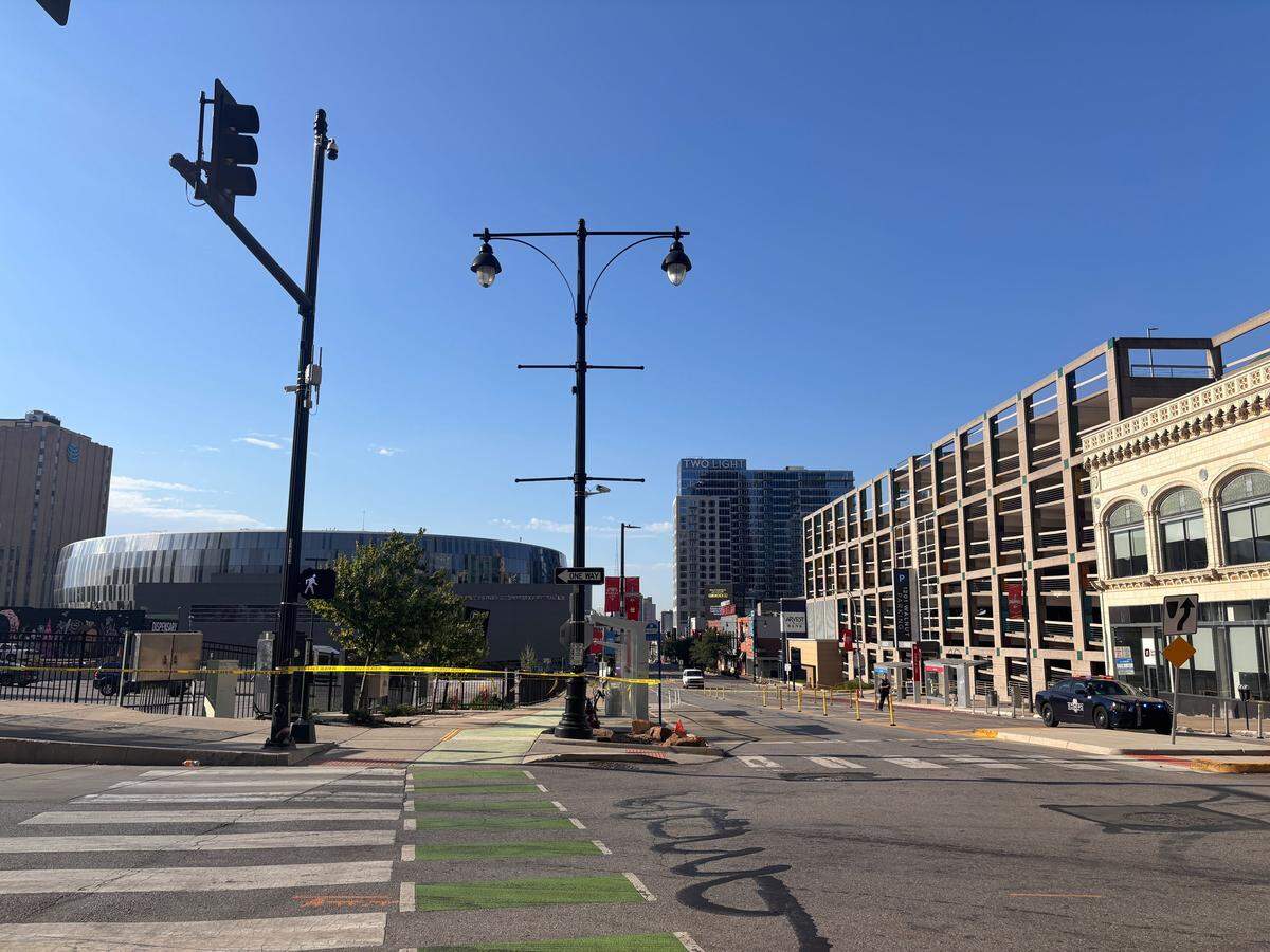 Police tape remained up Sunday morning after two people were killed in a shooting in a downtown Kansas City parking lot at 13th Street and Grand Blvd.