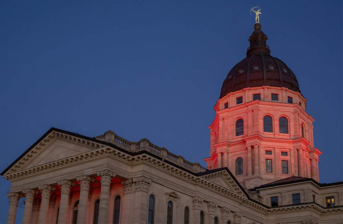 The Kansas Statehouse is bathed in red light after Kansas Governor Laura Kelly announced Monday, Dec. 22, 2025, that the Kansas City Chiefs will build their new stadium in Kansas City, Kansas. The decision marks a major win for the state, bringing one of the region's most prominent sports teams across the state line.