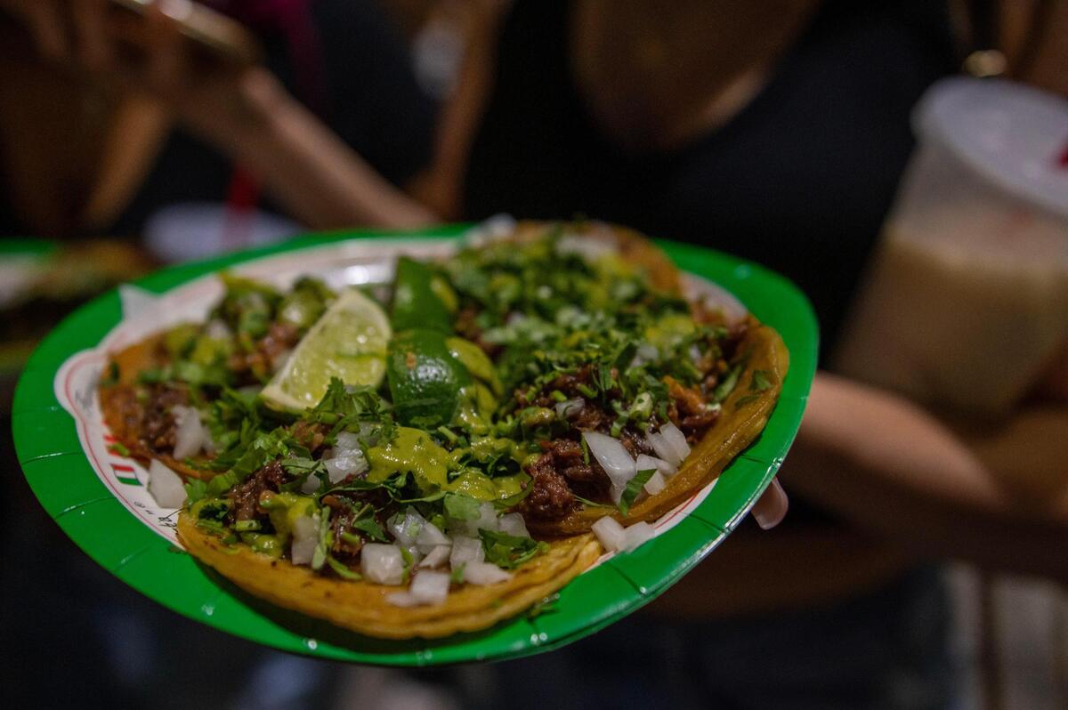 Street tacos topped with chopped onions, cilantro and hot sauce are seen on a visitor’s plate during the Cinco de Mayo celebration at Guadalupe Centers on Friday, May 5, 2023, in Kansas City.