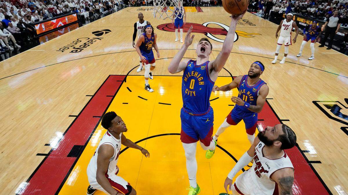 Denver Nuggets guard Christian Braun (0) shoots the ball against the Miami Heat during the second half in game three of the 2023 NBA Finals at Kaseya Center.