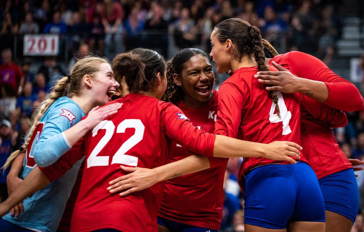Opposite London Davis (center) of Kansas women’s volleyball joins a team huddle during a match against K-State on November 2, 2022, at Horejsi Family Volleyball Arena.