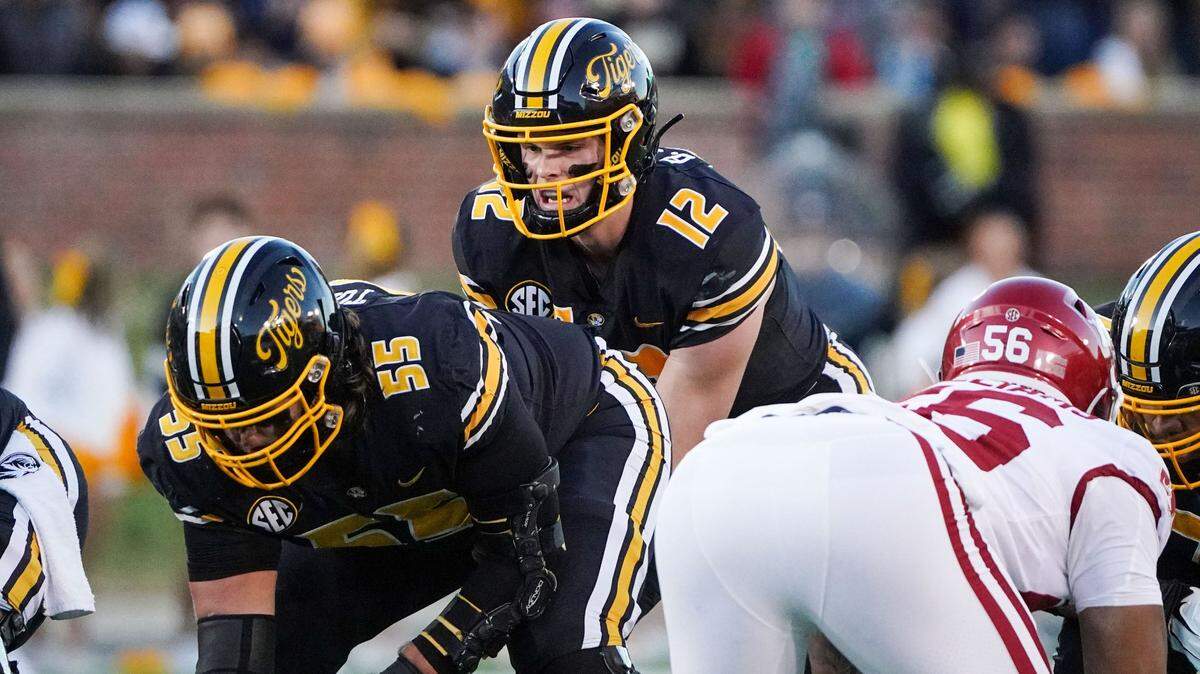 Missouri Tigers quarterback Brady Cook (12) and offensive lineman Connor Tollison (55) against the Arkansas Razorbacks during the game at Faurot Field at Memorial Stadium on Nov. 25, 2022.