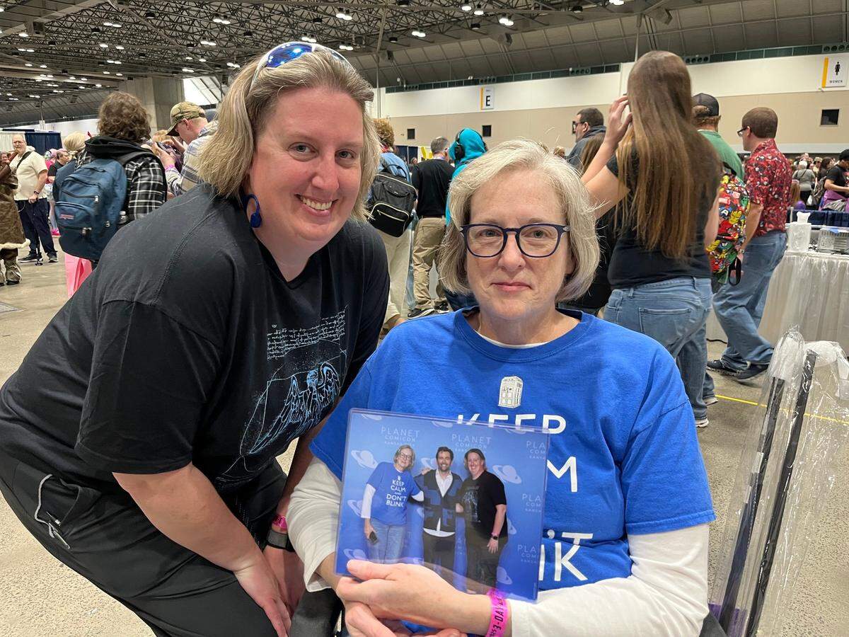 Rachel and Leanne Pace pose with their photo from Planet Comicon on Saturday, March 22, at the Kansas City Convention Center.