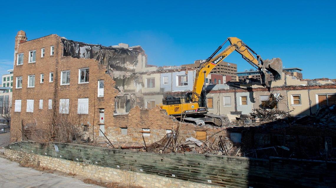 An excavator is used to demolish the Wiltshire apartment building at 703 E. 10th St. on Thursday in Kansas City.