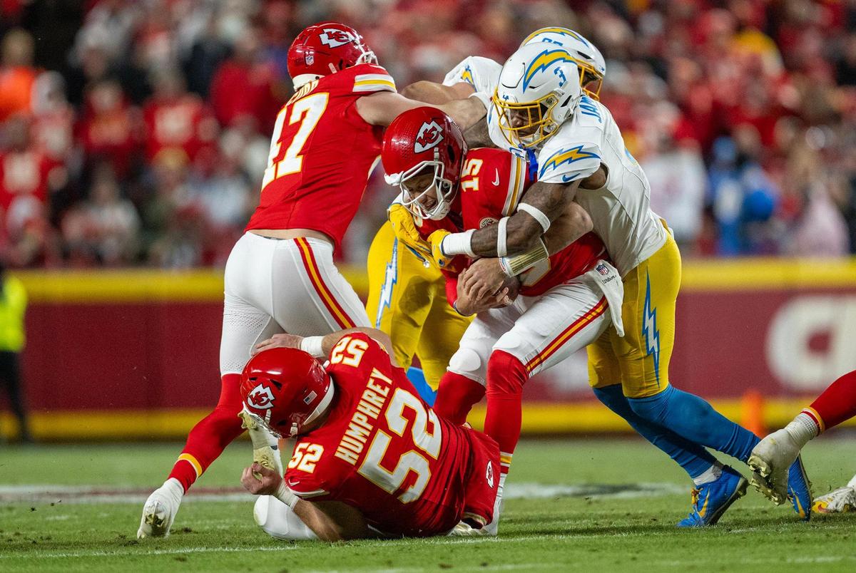 Kansas City Chiefs quarterback Patrick Mahomes (15) is sacked by Los Angeles Chargers safety Derwin James Jr. (3) Jr. on Sunday, Dec. 8, 2024, at GEHA Field at Arrowhead Stadium.