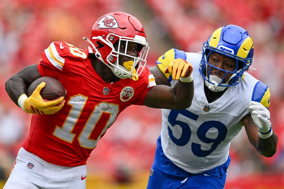 Kansas City Chiefs running back Emmett Johnson (10) tries to push off Los Angeles Rams linebacker Darryl Peterson III (59) in the second quarter of the Kansas City Chiefs vs. Los Angeles Rams preseason game at Arrowhead Stadium in Kansas City on Aug. 15, 2026.
