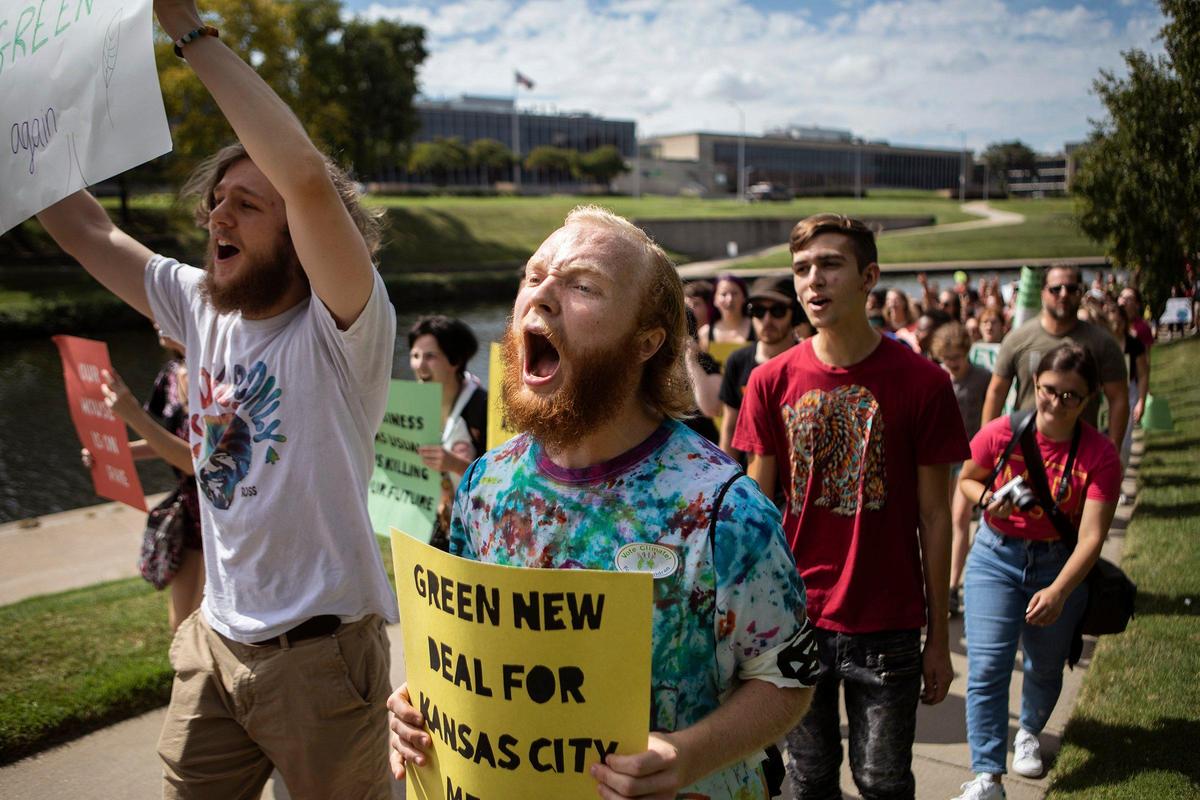 From left: Kyle Helm, Jesse Hill, Charlie Freeling, and others march back to the University of Missouri-Kansas City during the National Youth Climate Strike on Friday, Sept. 20, 2019. The march and rally were part of the Global Climate Strike.