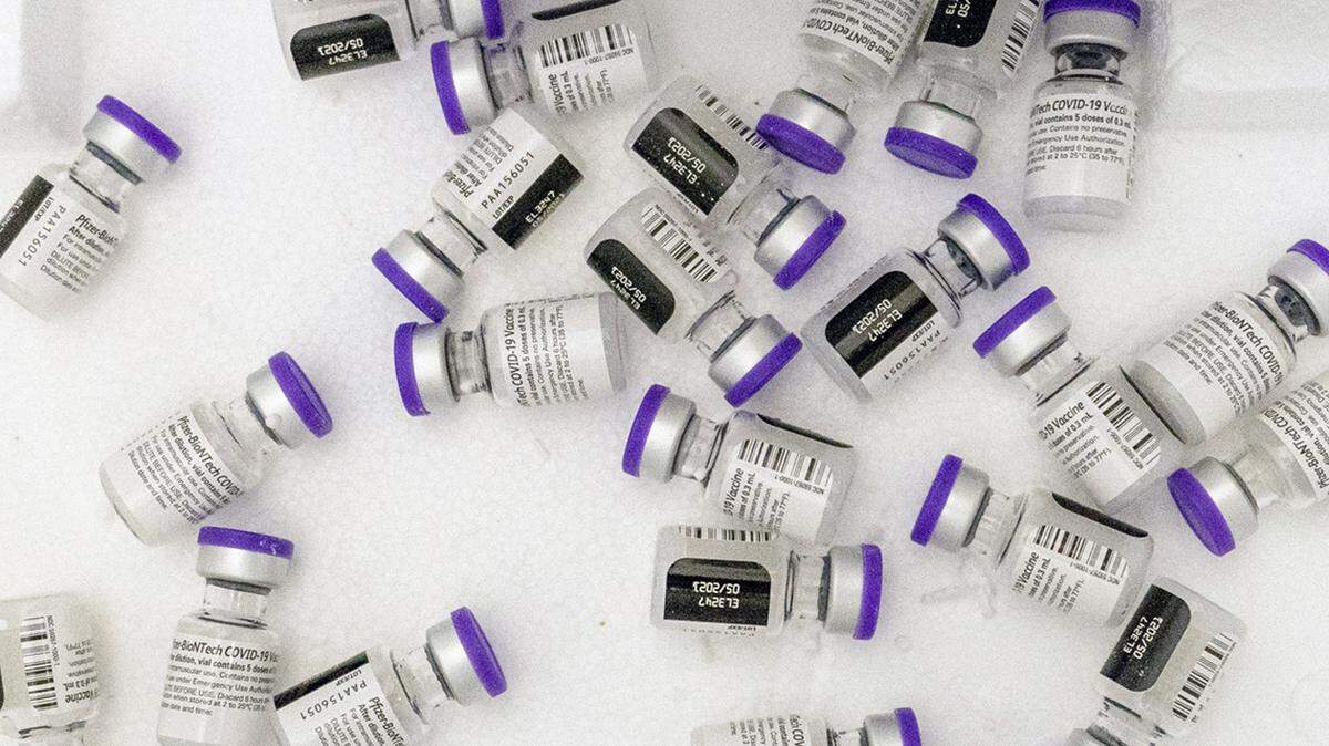 Vials of the Pfizer-BioNTech COVID-19 vaccine sit in a cooler before being thawed. A clinic in Antioch, California, gave incorrect doses of a COVID-19 vaccine to 14 pediatric patients, Sutter Health officials say.
