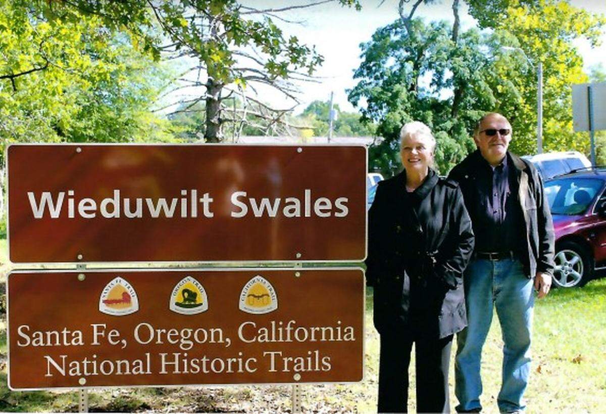 Sharon and Paul Wieduwilt stand at the marker for their namesake swales. Paul Wieduwilt had been headmaster of Blue Ridge Christian School in 1998 when it destroyed nearby Santa Fe Trail swales. “We should have known better,” he now says.