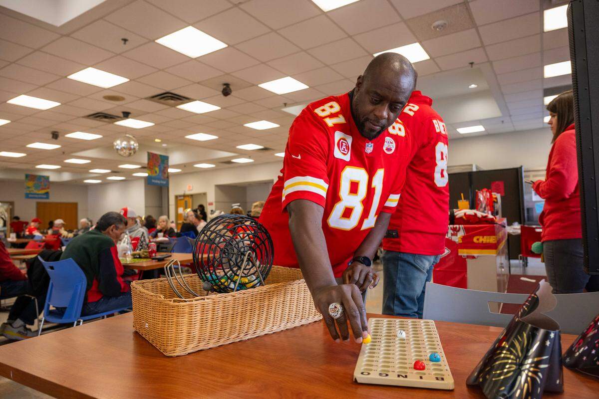 Former Kansas City Chiefs player Chris Penn marks numbers during a round of bingo at the Don Bosco Senior Center on Tuesday, December 30, 2025, in Kansas City. Kansas City Chiefs Ambassadors were in attendance to help ring in the new year.