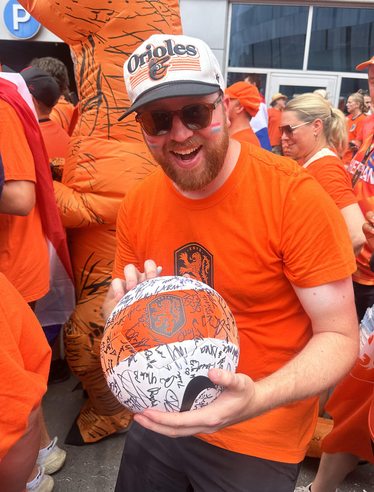Kalyn Ahrens holds up a soccer ball he brought to have signed by as many people as possible. Ahrens managed to get Mayor Quinton Lucas and two Dutch celebrities to sign.