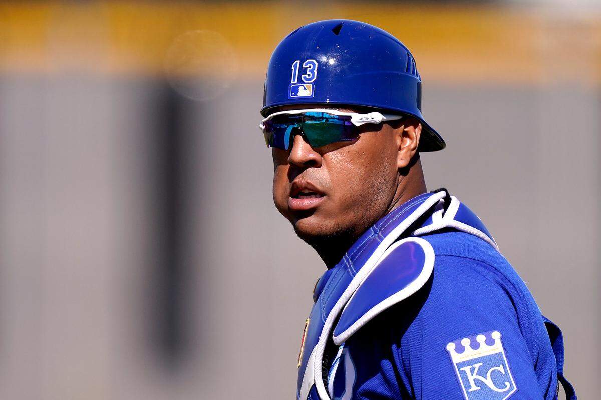 Kansas City Royals catcher Salvador Perez watches a drill during spring training baseball practice Monday, Feb. 22, 2021, in Surprise, Ariz. (AP Photo/Charlie Riedel)