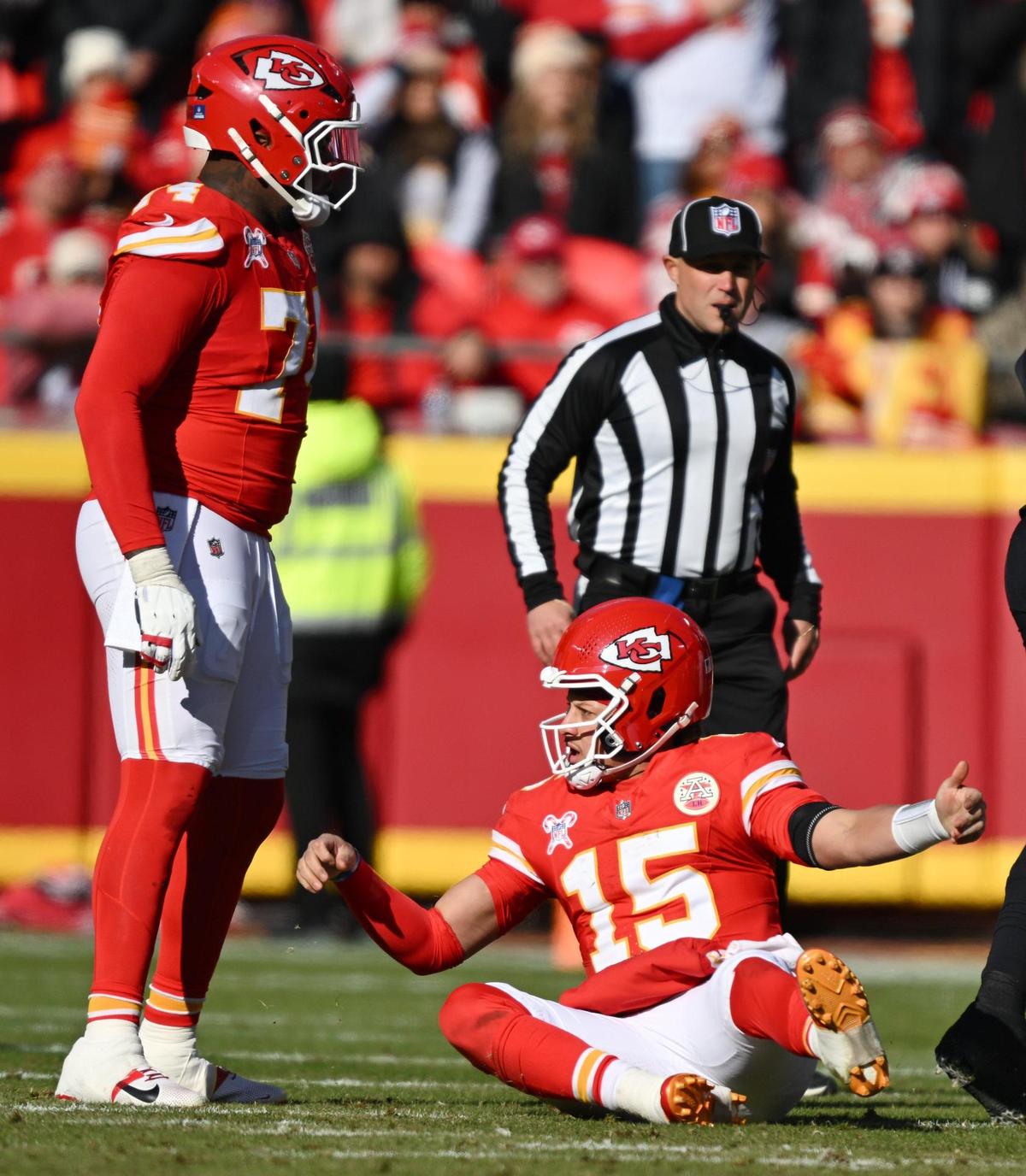 Kansas City Chiefs quarterback Patrick Mahomes (15) reacts after taking a shot to the head but the Houston Texans defense while throwing an incomplete pass in the second quarter on Saturday Dec. 21, 2024, at GEHA Field at Arrowhead Stadium.