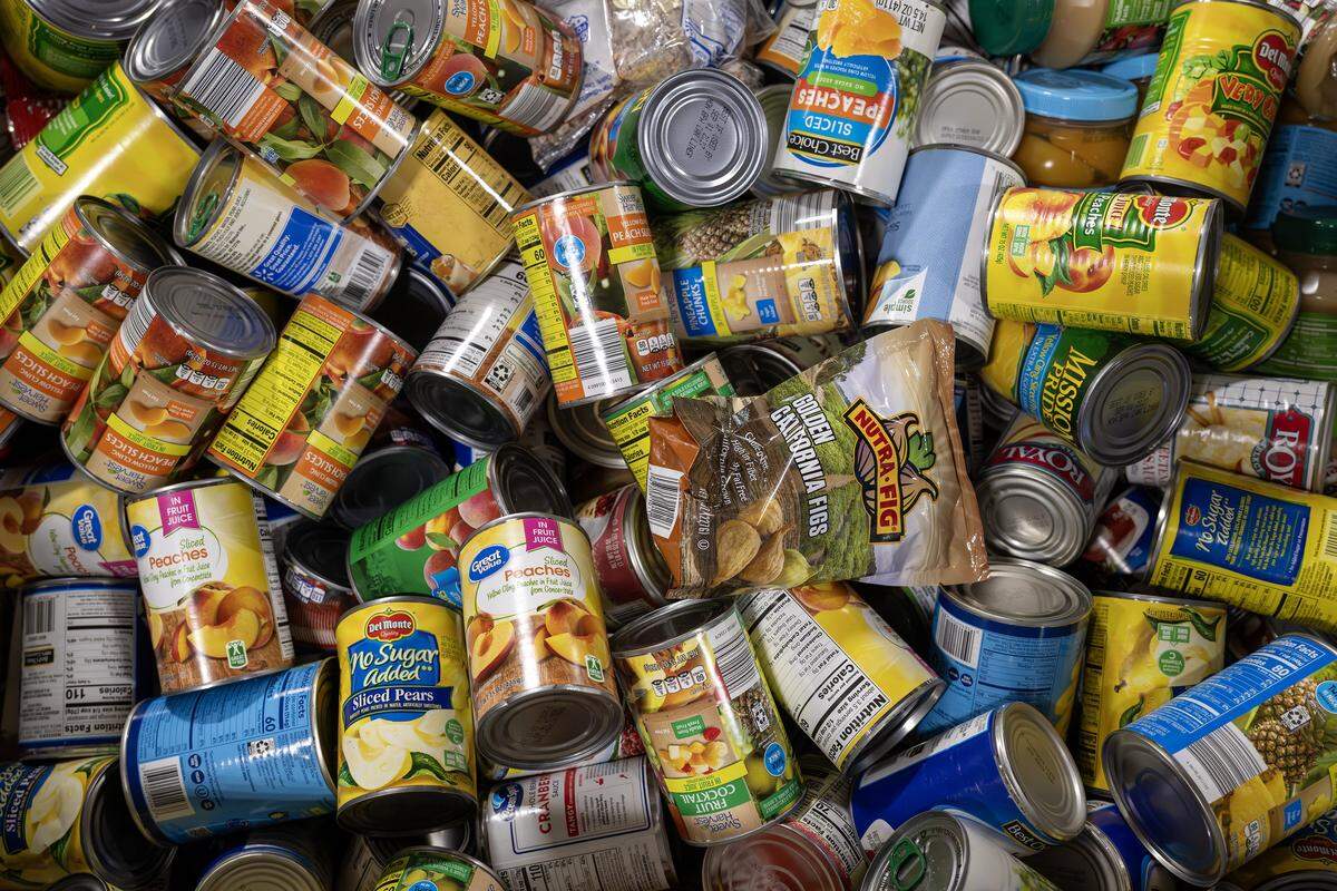 Canned goods are organized in large bins at the Harvesters distribution warehouse on Tuesday, Oct. 28, 2025, in Kansas City. The food bank is working to supply local pantries amid the government shutdown affecting SNAP benefits.
