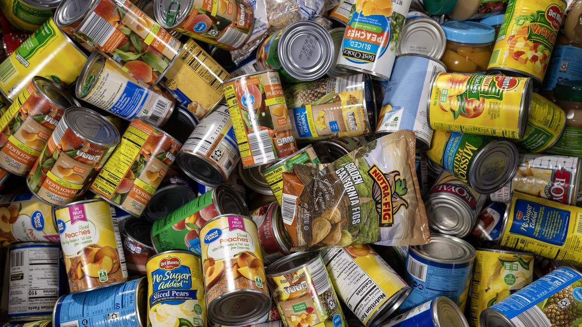 Canned goods are organized in large bins at the Harvesters distribution warehouse on Tuesday, Oct. 28, 2025, in Kansas City. The food bank is working to supply local pantries amid the government shutdown affecting SNAP benefits.