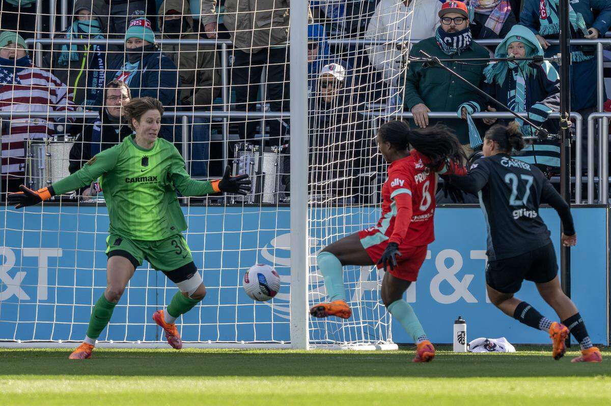 Gotham FC goalkeeper Ann-Katrin Berger, left, defends the net as KC Current forward Nichelle Prince takes a shot during an NWSL playoff match at CPKC Stadium in Kansas City on Sunday, Nov. 9, 2025.