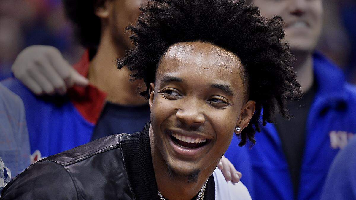 With some flashy Jayhawk bling dangling from his neck, former KU guard Devonté Graham joined about a dozen former KU players for a huge round of applause during the halftime of Saturday’s game against West Virginia.