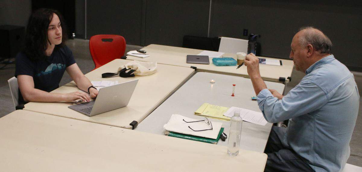 Young Playwrights Lab participant Gabe Baethke gets some pointers on his script from playwright Frank Higgins.