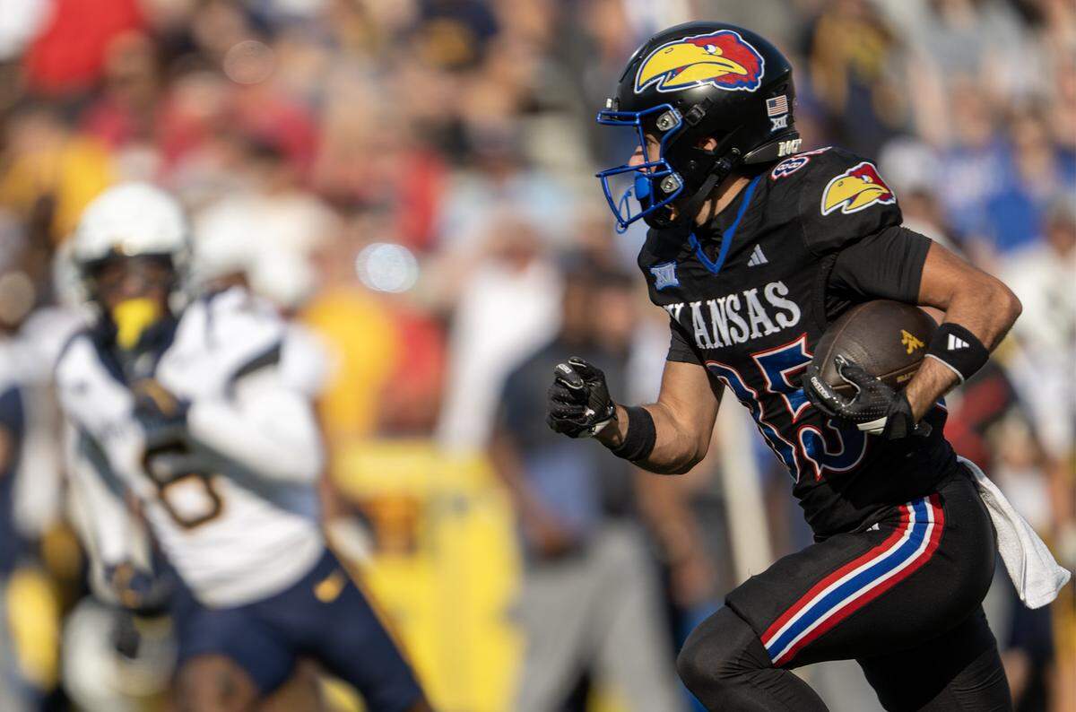 Kansas Jayhawks wide receiver Tate Nagy (85) runs the punt back in the first half of the game against the West Virginia Mountaineers at David Booth Kansas Memorial Stadium on Saturday, Sept. 20, 2025, in Lawrence.