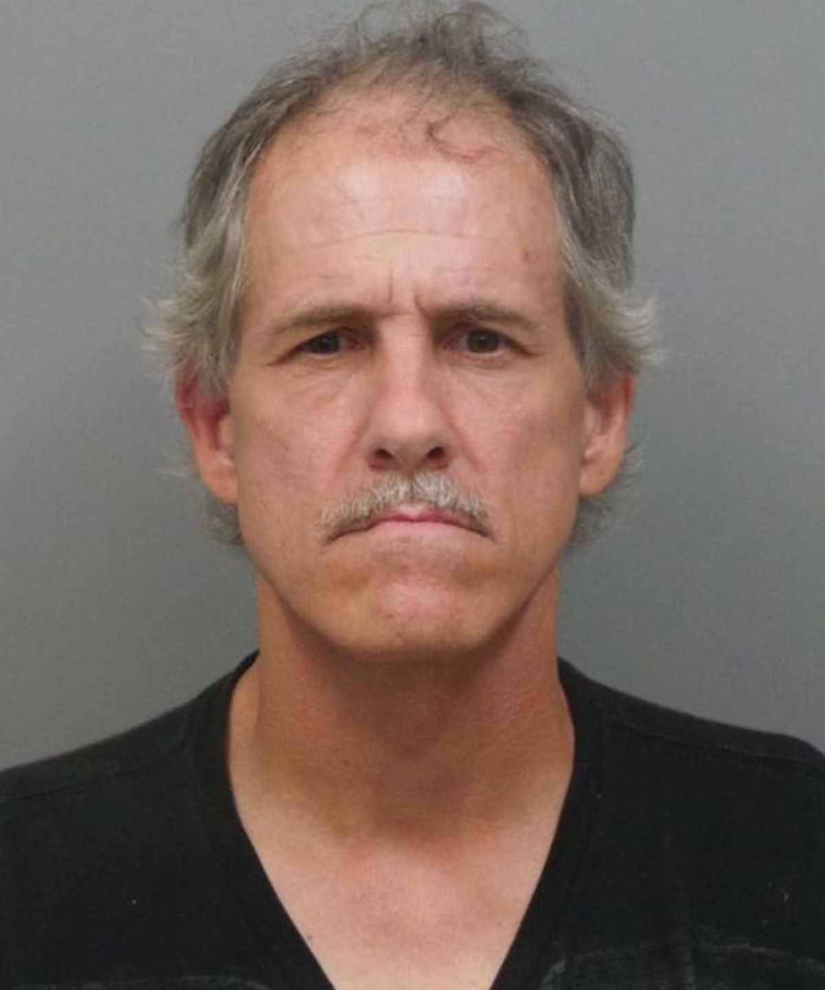 Police say Matthew S. McCloskey was fleeing the scene of an accident when he drove over a sidewalk and a lawn to get around a stopped school bus.