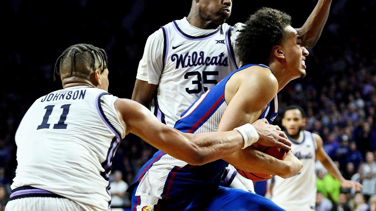 KU’s Jalen Wilson gets fouled while driving to the basket on KSU’s Keyontae Johnson and Nae’Qwan Tomlin during the second half a Big 12 Conference game at Bramlage Coliseum on Jan. 17, 2023. KSU beat KU 83-82 in overtime.