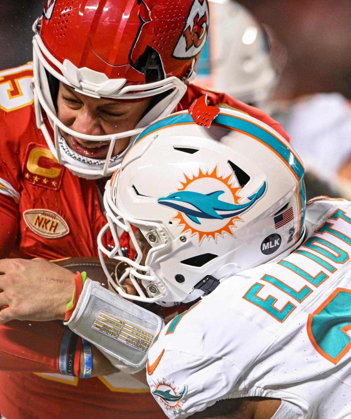 The helmet of Kansas City Chiefs quarterback Patrick Mahomes (15) breaks while being hit by Miami Dolphins safety DeShon Elliott (21) on a run in the third quarter Saturday, Jan. 13, 2024, at GEHA Field at Arrowhead Stadium.