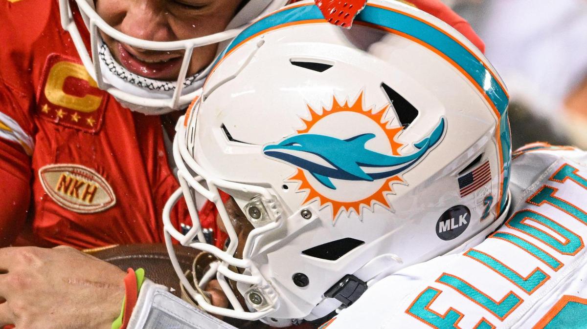 The helmet of Kansas City Chiefs quarterback Patrick Mahomes (15) breaks while being hit by Miami Dolphins safety DeShon Elliott (21) on a run in the third quarter Saturday, Jan. 13, 2024, at GEHA Field at Arrowhead Stadium.