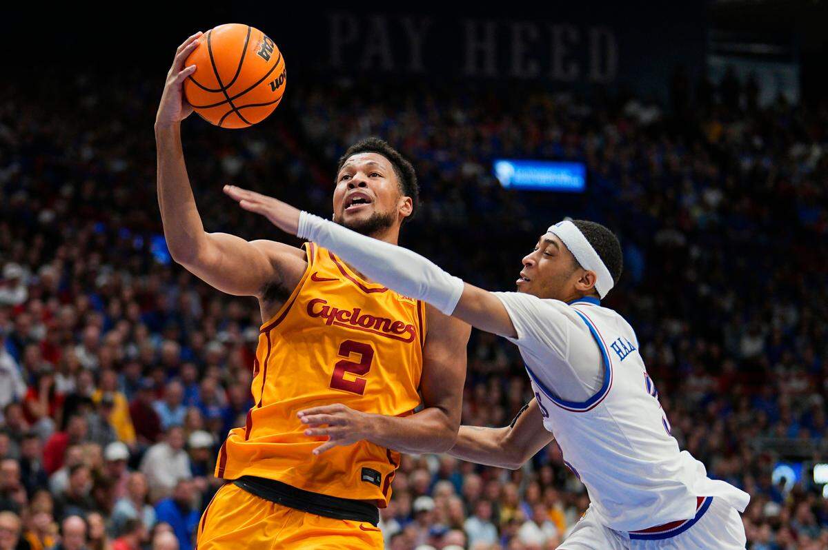 Kansas Jayhawks guard Dajuan Harris Jr., right, applies defensive pressure to shooting Iowa State Cyclones forward Joshua Jefferson during a college basketball game at Allen Fieldhouse in Lawrence, Kansas, on Monday, Feb. 3, 2025.