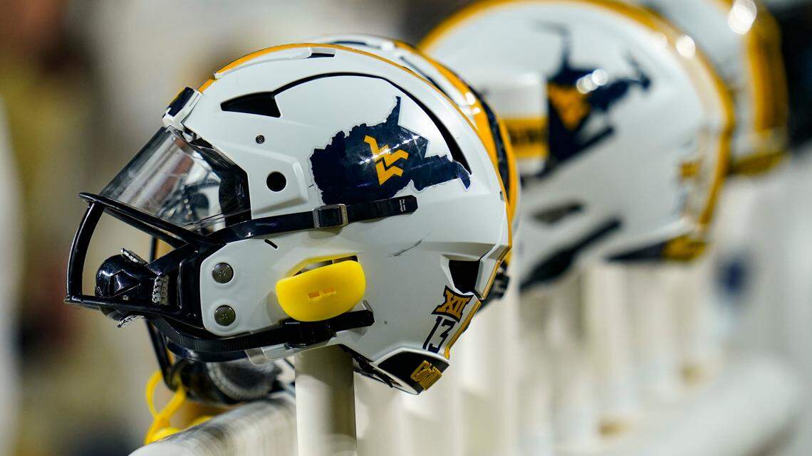 West Virginia football helmets are seen in the bench are during an NCAA college football game against Pittsburgh, Thursday, Sept. 1, 2022, in Pittsburgh. (AP Photo/Keith Srakocic)